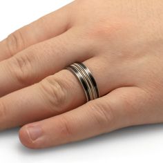 Perfect for the groom who loves music, this men's wedding band has two guitar strings running throughout the dark ebony wood. Send us your own guitar string to use in the creation of the ring for a personalized design like no other. RING LAYOUTRing Width: 8 mmRing Sleeve: TitaniumRing Profile: FlatRing Finish: Matte 0.5 mm Titanium1.5 mm Ebony Wood0.5 mm Titanium1.25 mm Guitar String0.5 mm Titanium1.25 mm Guitar String0.5 mm Titanium1.5 mm Ebony Wood0.5 mm Titanium Love For Music, Guitar Strings, Ebony Wood, Ring Sizer, Wood Jewellery, Mens Wedding Bands, Wedding Men, Wedding Band, Wedding Bands