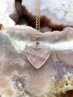 Pretty in pink. This large rose quartz crystal heart pendant necklace is the perfect healing piece to add to your jewelry collection. Exuding dusty soft shades of pink, rose quartz helps soothe your heart and emit love to those all around you. Embrace the delightful beauty and tranquil benefits of this gentle and graceful creation.    Pink Rose Quartz Crystal Pendant Necklace *Beautifully polished rose quartz *Soft and feminine style *Loving calm energy -- speaks directly to your heart chakra *1 Pink Spiritual Necklaces With Heart Beads, Pink Rose Quartz Crystal Necklace Gift, Handmade Pink Heart Crystal Necklaces, Valentine's Day Pink Rose Quartz Jewelry, Pink Rose Quartz Heart Beads Jewelry, Pink Gemstone Heart Necklace, Pink Crystal Necklaces For Valentine's Day, Pink Crystal Necklace For Valentine's Day Jewelry Making, Rose Gold Heart-shaped Rose Quartz Jewelry