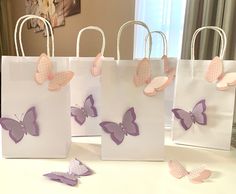 three bags with butterflies on them sitting on a table