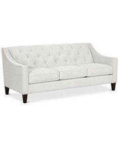 a white couch sitting on top of a wooden floor