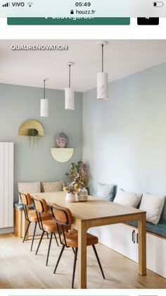 a dining room table with four chairs and a bench in front of the wall,