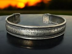 Vintage Boho silver tone animal print cuff bangle. Central animal print band with a twisted rope edge either side. In good vintage condition. I have given it a gentle clean to try to retain the vintage patina. Cuff bangle is 1 cm wide or 3/8" Approx 6.5 cm wide / just over 2.6" but can be adjusted. Comfortably fits my 7" wrist. No makers marks or hallmarks. Adjustable Antique Silver Cuff Bangle, Handmade Adjustable Antique Silver Cuff Bracelet, Boho Bracelet, Cuff Bangles, Boho Bracelets, Vintage Boho, Makers Mark, Vintage Silver, Cuff Bracelets