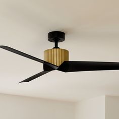 a black ceiling fan with a golden light fixture