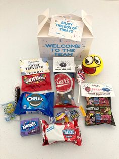 a box filled with candy and snacks on top of a table