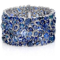 The Enchanted Evening Celeste Bracelet by Ruchi New York is a piece of fine jewelry that is sure to catch the eye of any woman looking for a unique and luxurious accessory. This stunning cuff bracelet is handcrafted with organic shapes of sapphire nuggets mixed with varying shades of faceted sapphires. The result is a one-of-a-kind piece that exudes sophistication and glamour. With 123.38 carats of blue sapphires and 1.64 carats of diamonds, this bracelet is truly a statement piece that will be Elegant Blue Multi-stone Bracelet, Elegant Sapphire Multi-stone Bracelet, Elegant Blue Multi-stone Bracelets, Elegant Multi-stone Sapphire Bracelet, Unique Formal Gemstone Bangle, Fine Sapphire Bangle Jewelry, Unique Formal Bangle With Gemstone, Sapphire Gemstone Bangle Jewelry, Elegant Multi-stone Cuff Bangle Bracelet