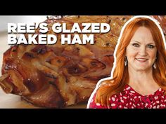 a woman standing in front of some baked ham