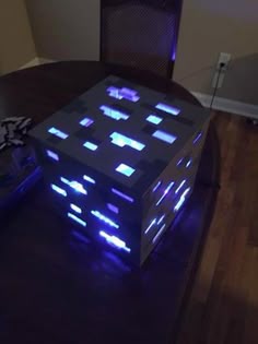 a table that has some kind of electronic device on top of it with blue lights