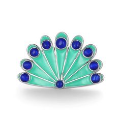 a blue and green broochle sitting on top of a white surface