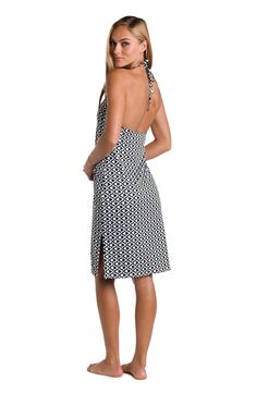 This cover up dress showcases a geometric black and white print, featuring a repetitive, interlocking pattern that gives a sense of intricate tessellation. The high-contrast design creates a striking optical effect, which is both modern and timeless. It features a halter neck style with a sleek, body-hugging silhouette and a knee-length hem, creating an elegant and sophisticated look. [split] Details V-neck midi dress Bra cups Side slits Adjustable neck tie Gold charms Wear solo or as a cover-up Black Beach Dress With Geometric Pattern, Black Geometric Pattern Beach Dress, Black Vacation Dress With Geometric Pattern, Black Geometric Pattern Sleeveless Dress, Black Sleeveless Dress With Geometric Pattern, Black Dress With Geometric Pattern For Vacation, White Geometric Pattern Dress For Vacation, Interlocking Pattern, Geometric Black And White