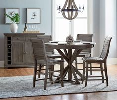 a dining room table with chairs and a fire place in the corner next to it