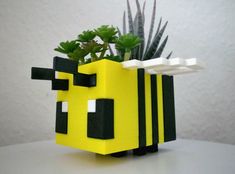 a planter made out of lego blocks with succulents in the middle