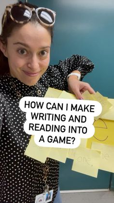 a woman holding up a piece of paper with the words how can i make writing and reading into a game?