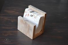 a wooden holder with two napkins in it