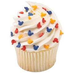 a cupcake with white frosting and red, blue, and yellow decorations on it