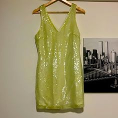 Sparkly Lime Green Mini Dress With Comfortable Lining And No Sleeves With A Gorgeous V Neck. Very Very Flattering! Never Worn, But Not With The Original Tag. Elevate Your Party Wardrobe With This Exquisite Lime Green Sequin Mini Dress, A Glamorous Masterpiece That Effortlessly Captures Attention And Radiates Sophistication. Crafted With Meticulous Attention To Detail, This Dress Is Perfect For Making A Bold Statement At Any Event. The Dazzling Lime Green Sequins Create A Mesmerizing Play Of Ligh Yellow V-neck Party Dress, Yellow V-neck Dress For Party, Yellow Fitted Dress For Party Season, Yellow Sequin Party Dress, Yellow V-neck Dress For Night Out, Yellow Sleeveless Mini Dress For Party, Green Sequin Summer Dresses, Yellow Sleeveless Dress For Party Season, Sleeveless Yellow Dress For Party Season