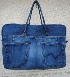 a denim bag with two pockets on the inside