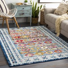 a living room area with a couch, chair and rug