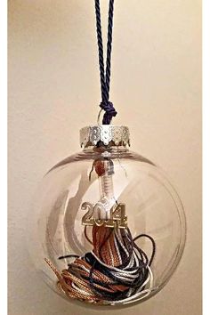 a glass ornament filled with lots of wires and cords hanging from a cord