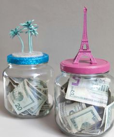 two jars with money in them and the eiffel tower sticking out of one