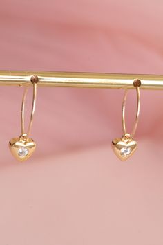 Mini gold-plated hoop earrings decorated with a fine gold-plated heart. They are a minimalist and refined jewel. They are 15 mm in diameter. For pierced ears. The heart is 8 mm high and 7 mm wide. Their sober and minimalist look makes these hoop earrings the perfect gift for a special occasion! My jewelry is assembled by hand in my workshop in Paris. All my jewelry is shipped in a pretty pink suede pouch. To preserve the shine of your jewelry, avoid contact with perfume, cosmetics or chemicals. Tarnish Resistant Gold Plated Dainty Heart Earrings, Dainty Heart-shaped Tarnish-resistant Huggie Earrings, Dainty Tarnish Resistant Hoop Earrings For Valentine's Day, Minimalist Gold Heart Earrings With Charm, Minimalist Gold Plated Heart Earrings, Gold Plated Hoop Earrings For Everyday And Valentine's Day, Dainty Heart-shaped Gold-plated Earrings, 14k Gold Hoop Earrings With Heart Charm, Gold Plated Heart Charm Earrings