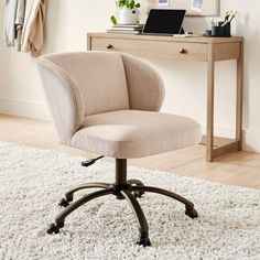 an office chair sitting on top of a white rug in front of a wooden desk