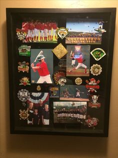 a baseball player's memorabilia is framed in a black shadow box on the wall