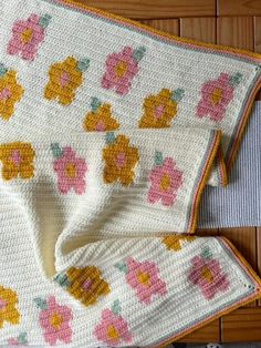 a crocheted blanket with flowers on it