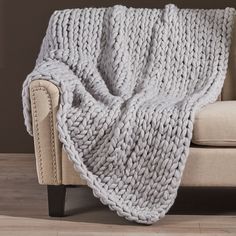 a large chunky blanket draped over a couch