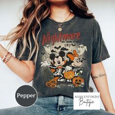 a woman wearing a mickey mouse halloween shirt