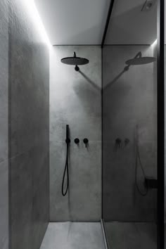 a walk in shower sitting inside of a bathroom next to a wall mounted faucet