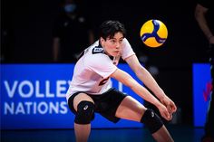 a man in white shirt and black shorts playing volleyball