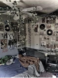 a bed room with a bunch of pictures on the wall