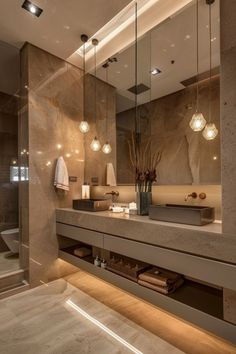 a bathroom with a large mirror, sink and shower stall in it's center