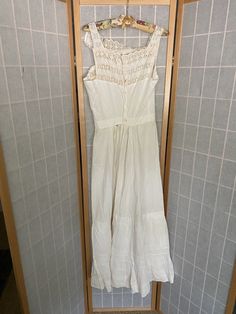 "Early 1900's white cotton petticoat dress. Buttons up the back, lace eyelet straps, large rip and stain spot. A couple of other small rips, being sold as is Bust: 34/35\" Waist: 25\" Hips: up to 47\" Armpit to hem: 45\"" Victorian Cotton Dress For Summer, Summer Wedding Vintage Cotton Dress, Victorian Style Cotton Summer Dress, Summer Wedding Victorian Cotton Dress, Victorian Vintage Dress With Lace Trim For Summer, Victorian Lace Trim Dress For Summer, Victorian Lace Vintage Dress For Summer, Summer Victorian Dress With Lace Trim For Daywear, Vintage White Victorian Dress For Summer Wedding