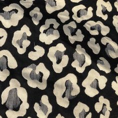 an animal print fabric with white and black spots