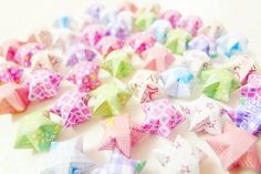 colorful origami stars on a white surface