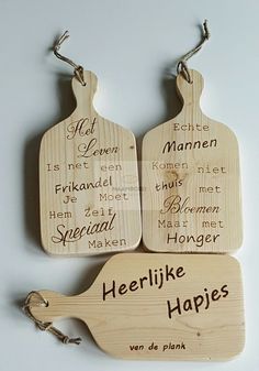 three wooden cutting boards with words written on them, one has a spoon and the other has a knife