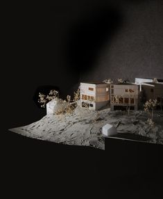 the model houses are on the surface of the moon, with plants growing out of them