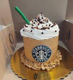 a starbucks coffee cake with whipped cream and chocolate sprinkles in a cardboard box