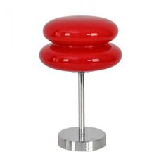 a red stool sitting on top of a metal stand