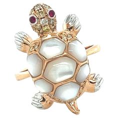 Tortoise White Shell 18K Rose Gold Ring 28 Diamonds 0.30CT 2 Rubies 0.03CT 7 White Pearls 2.45CT 18 K Rose Gold 5.42GM The pearl meaning is centered around purity, balance, and inner wisdom. Pearls have long been a source of pure fascination. Silky and glistening with many shades, these precious gems seem to carry a one-of-a-kind energy. Often tagged as being gifts of grace and glamor, pearls also carry a luminous water energy and a sense of harmony as they are created in synergy with other livi Tortoise Rings For Men, Pearl Meaning, Tortoise Ring, Thali Decoration Ideas, K Rose, Water Energy, Inner Wisdom, The Pearl, Precious Gems