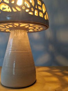 a white table lamp sitting on top of a wooden table