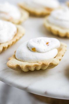 several small desserts are on a white plate