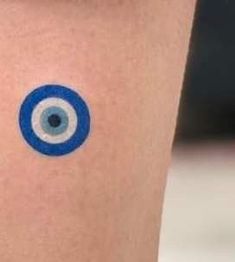 an evil eye tattoo on the leg