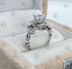 a diamond ring sitting in a box on top of a table