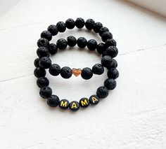 Beaded Name Bracelets black lava bead with black and gold letters for Women and Men, Boys and Girls. Customize the lava bead bracelets with a name of your choice choose between a few different styles or wear them as a set! How to Order 1) Choose a Style and Size 2) Add name to personalization box 3) Add to Cart Handmade with Love and Care >Jewelry Care Tips< * Care should be used to avoid unnecessary over-stretching. * Take off bracelets when showering or bathing  *Every Bracelet is Unique in it Bracelet Word, Mom Jewelry Personalized, Mama Bracelet, Name Bracelets, Bracelets Black, Essential Oil Bracelet, Lava Bead Bracelet, Word Bracelet, Lava Bead