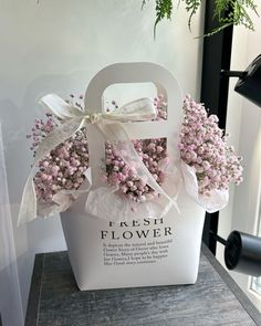 a white bag with pink flowers in it