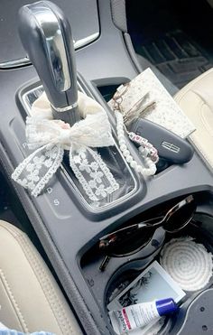 the inside of a car with sunglasses and other items