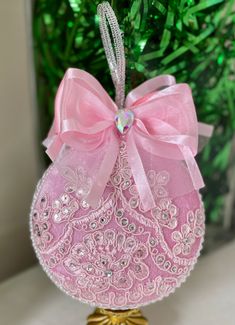 a pink ornament with a bow on it