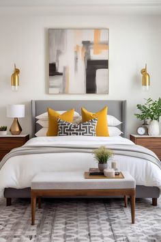 a bedroom with white bedding and yellow pillows on the headboard, along with two nightstands